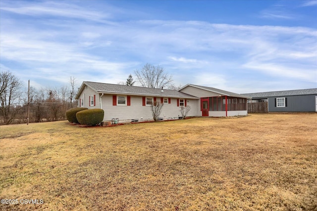 ranch-style house with a front lawn and a sunroom