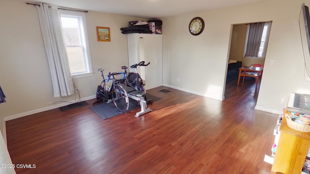 workout area with dark hardwood / wood-style flooring