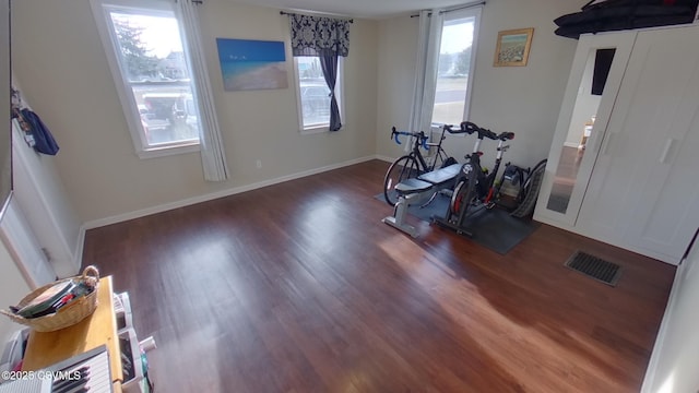 workout area featuring dark hardwood / wood-style flooring