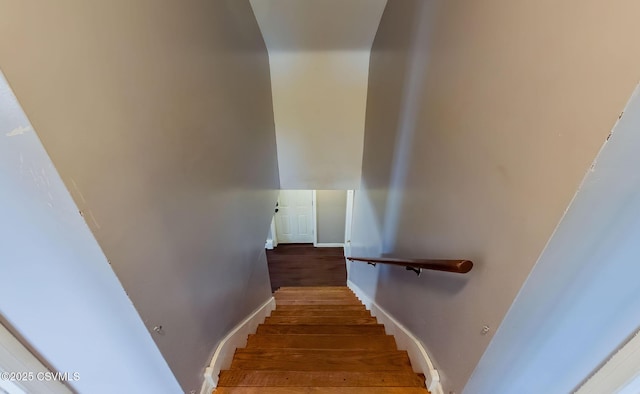 stairway with baseboards and wood finished floors