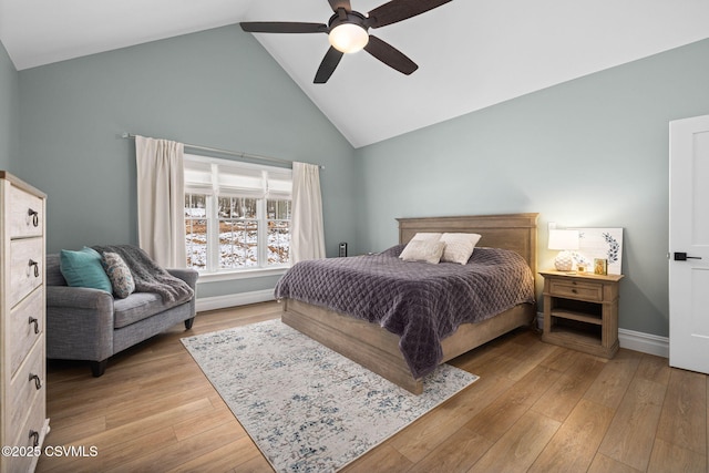 bedroom with ceiling fan, high vaulted ceiling, and light wood-type flooring