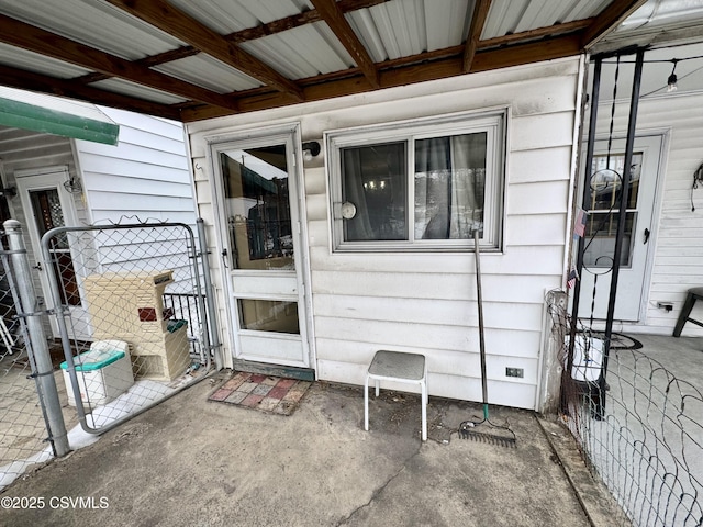 view of exterior entry with a patio area