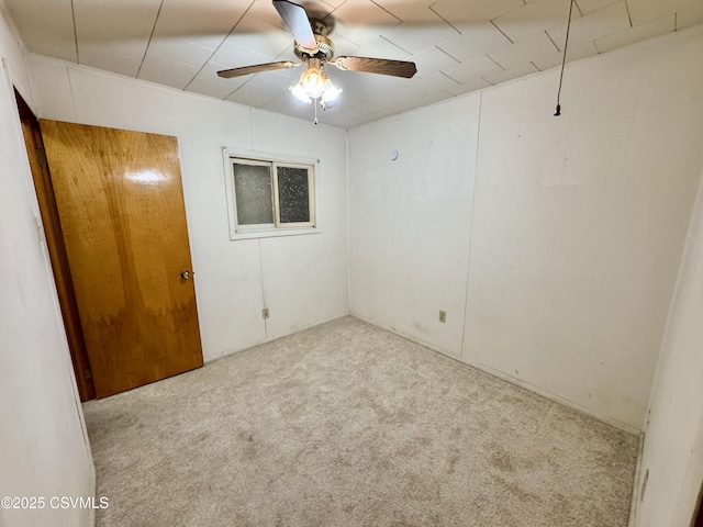 spare room featuring ceiling fan and light colored carpet