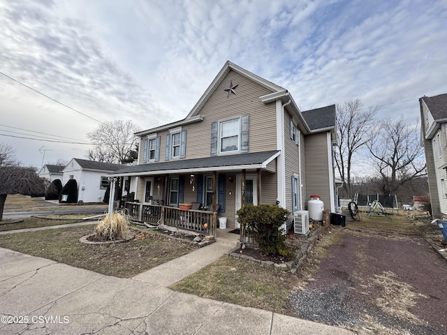 view of front of house featuring a porch and a trampoline