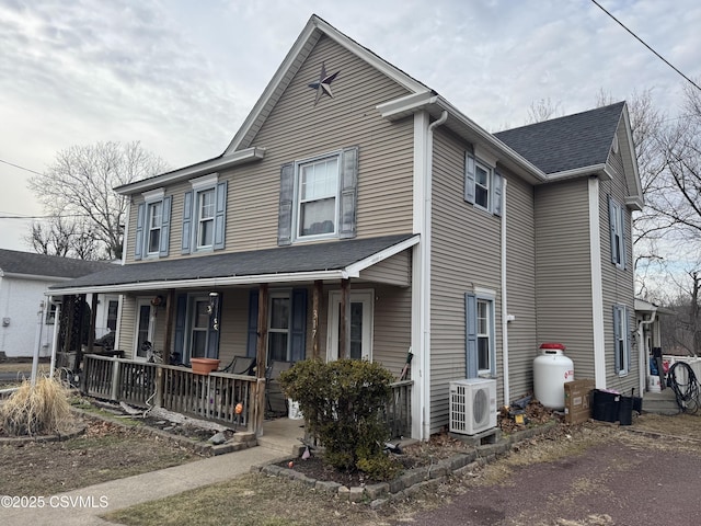 view of front of house featuring covered porch, roof with shingles, and ac unit