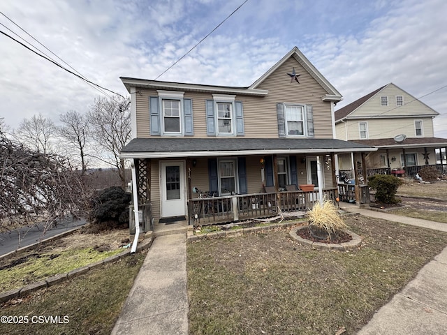 view of front of house with a porch and a front yard