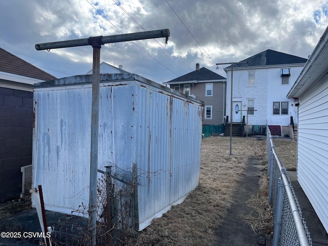 view of yard with entry steps, fence, and an outdoor structure