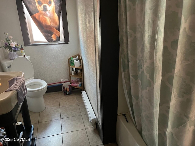 bathroom featuring a textured wall, shower / bathtub combination with curtain, toilet, a baseboard heating unit, and tile patterned flooring