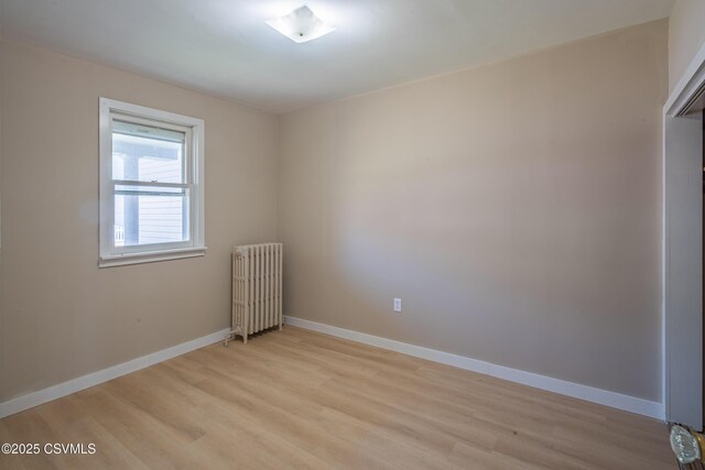 1041 Pine St, Kulpmont, PA 17834 - empty room with radiator and light wood-type flooring