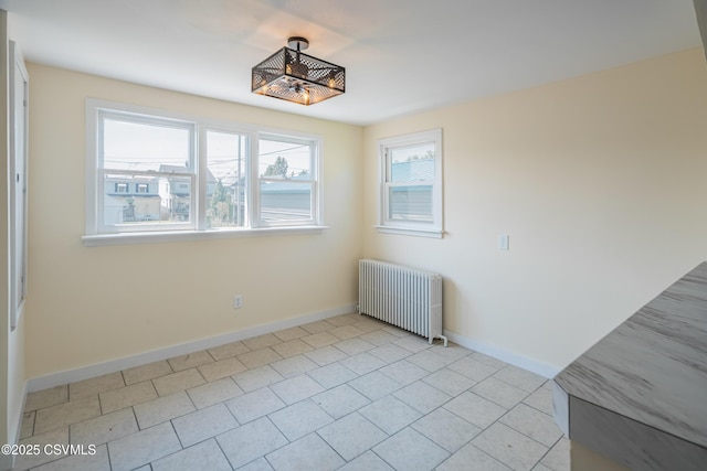1041 Pine St, Kulpmont, PA 17834 - unfurnished dining area with radiator heating unit and light tile patterned flooring