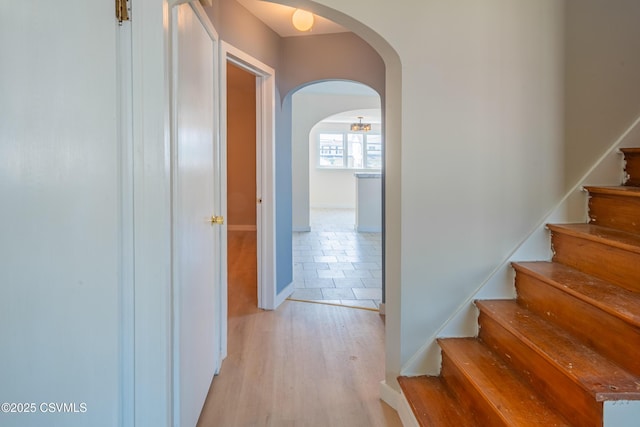 1041 Pine St, Kulpmont, PA 17834 - hallway with arched walkways, light wood-style flooring, and stairway
