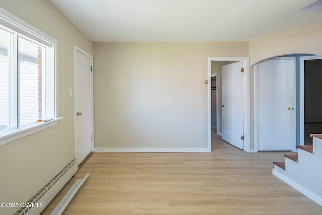 1041 Pine St, Kulpmont, PA 17834 - unfurnished room with a baseboard radiator, light wood finished floors, and stairway