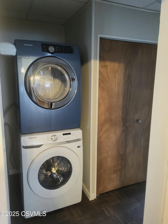 washroom featuring laundry area and stacked washer / dryer