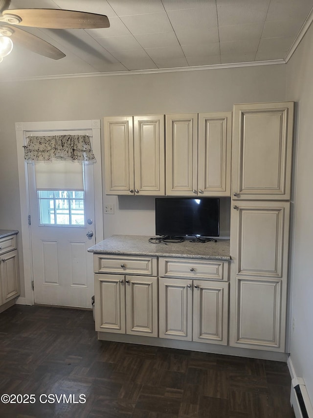 kitchen featuring ceiling fan, a baseboard heating unit, light stone counters, and crown molding