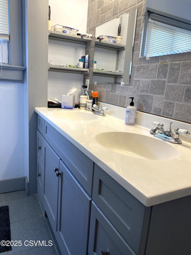 bathroom featuring double vanity, tile patterned flooring, and a sink