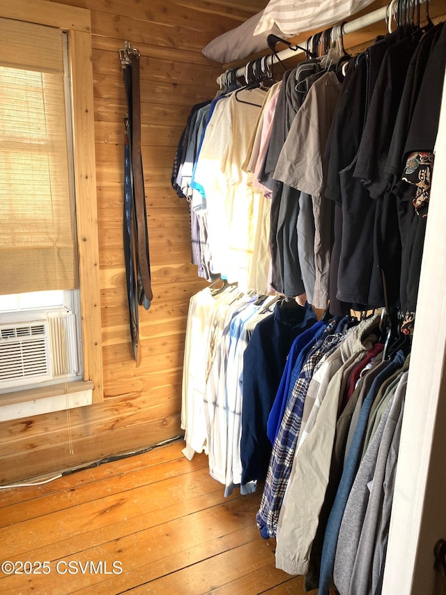 spacious closet featuring cooling unit and hardwood / wood-style flooring