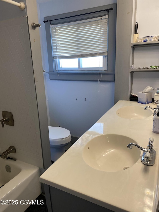 full bathroom featuring double vanity, toilet, a sink, and bathing tub / shower combination