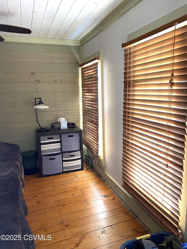 interior space with wood walls, wooden ceiling, and light wood-style flooring