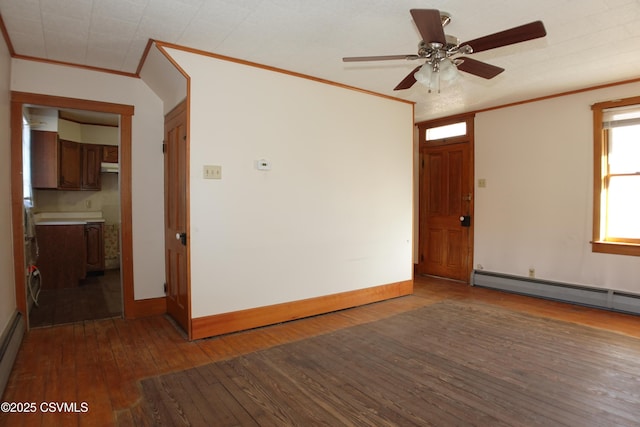 spare room featuring ceiling fan, baseboard heating, dark hardwood / wood-style flooring, and ornamental molding