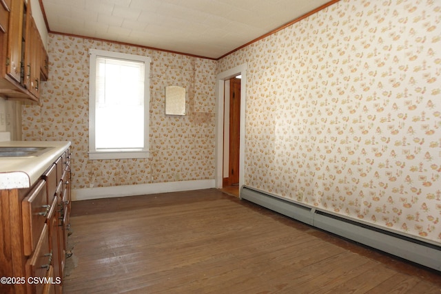 kitchen featuring ornamental molding, dark wood-type flooring, and a baseboard heating unit