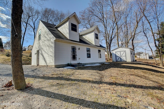 view of property exterior featuring an outdoor structure and a shed