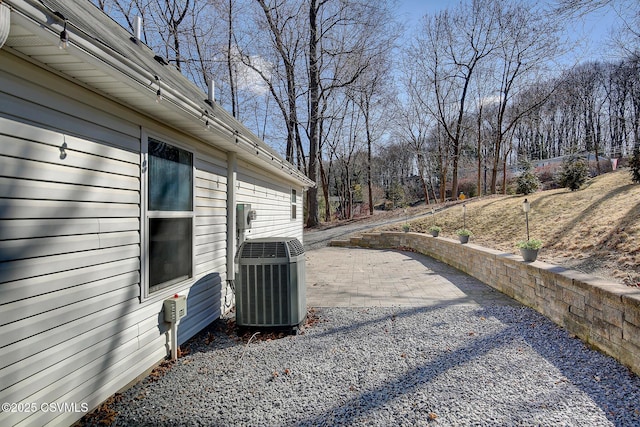 view of yard with central AC unit and a patio area