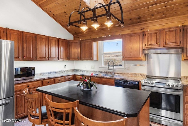 kitchen with stainless steel appliances, a sink, a center island, and brown cabinets