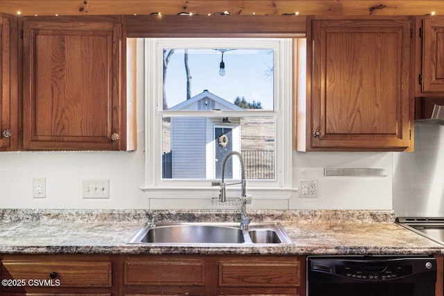 kitchen with dishwasher, a sink, and brown cabinets