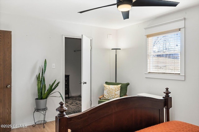 bedroom with a ceiling fan, light wood-type flooring, and baseboards