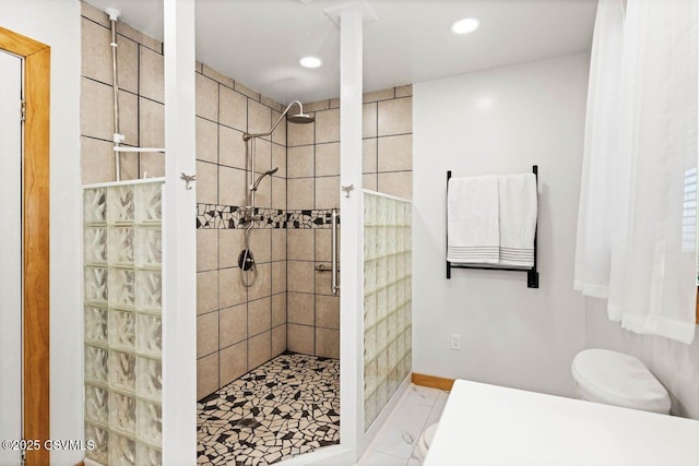 bathroom with toilet, baseboards, walk in shower, and recessed lighting