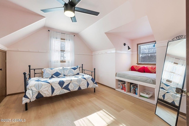 bedroom with lofted ceiling, ceiling fan, and light wood finished floors