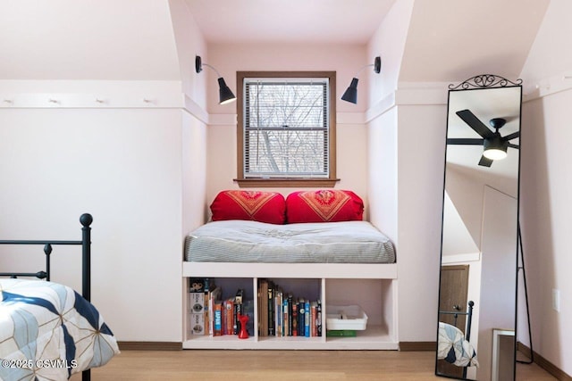 bedroom featuring baseboards and wood finished floors