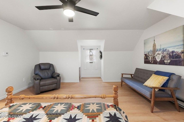 living area featuring ceiling fan, baseboards, vaulted ceiling, and wood finished floors