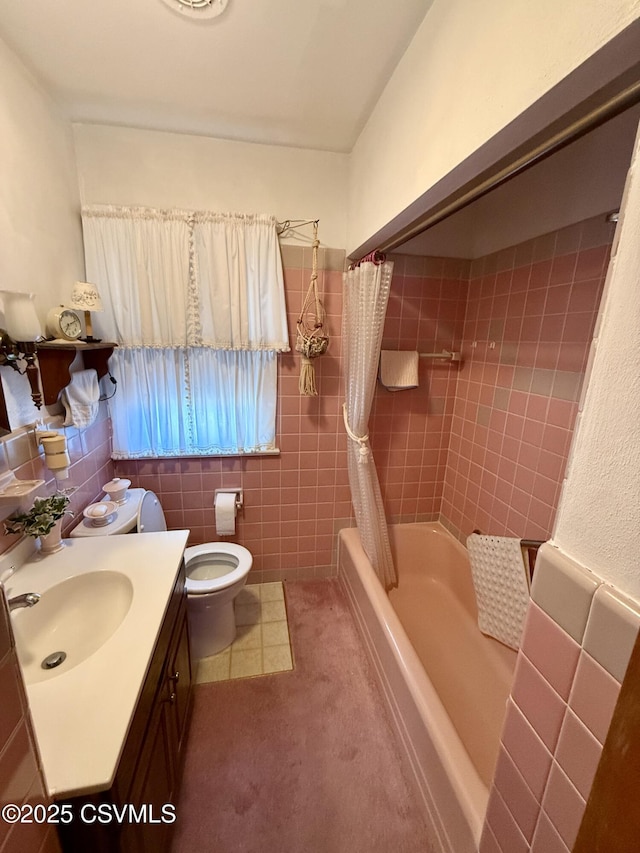 full bathroom with toilet, shower / tub combo, tile walls, and vanity