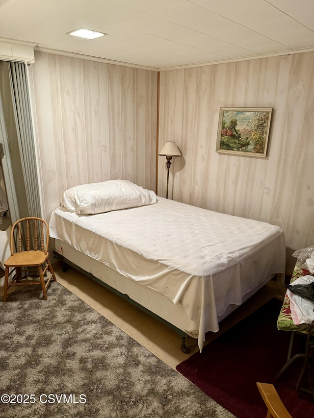 bedroom featuring wood walls