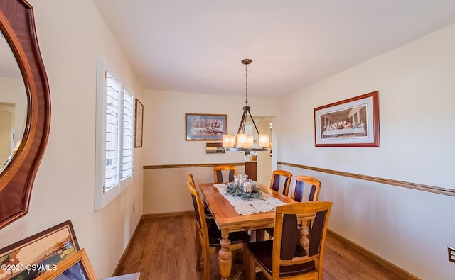 dining room featuring baseboards and wood finished floors