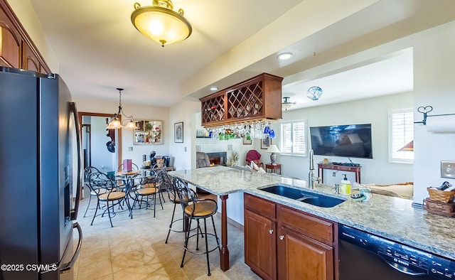 kitchen featuring a sink, plenty of natural light, stainless steel fridge, and dishwasher