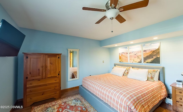 bedroom featuring ceiling fan, wood finished floors, and baseboards