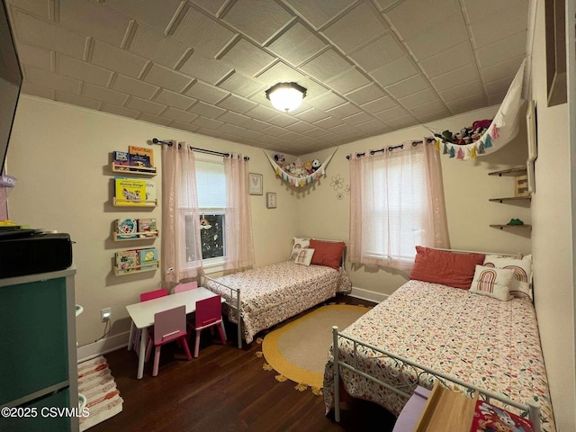 bedroom featuring dark wood-type flooring and baseboards