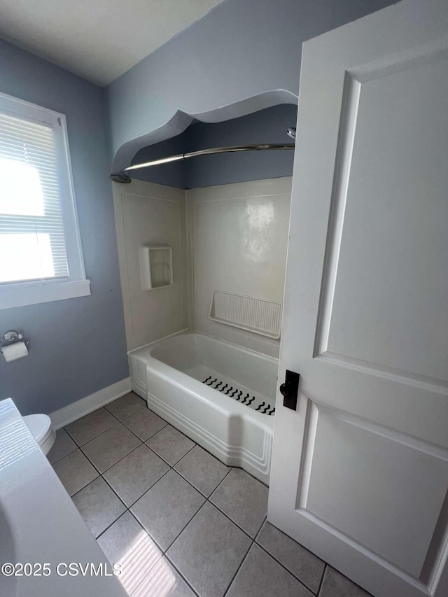 full bathroom with  shower combination, tile patterned flooring, baseboards, and toilet