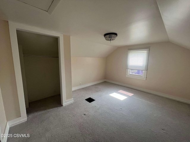 additional living space with lofted ceiling, carpet flooring, and baseboards