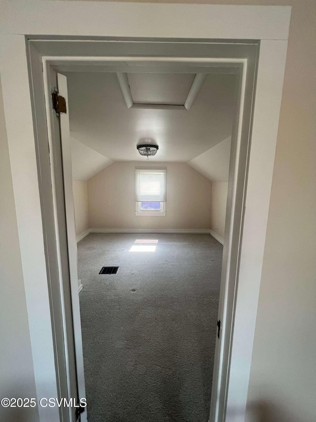 bonus room with lofted ceiling, carpet flooring, visible vents, and baseboards