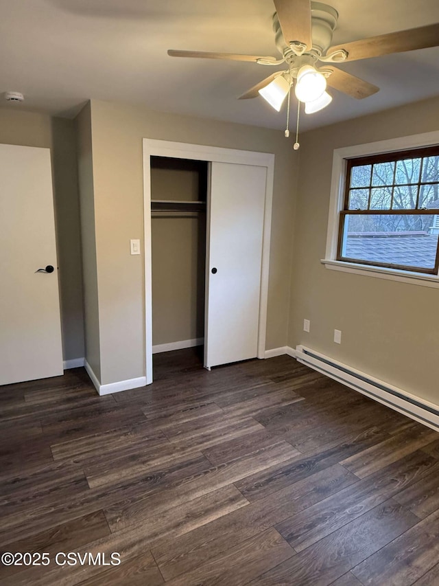 unfurnished bedroom with ceiling fan, a closet, dark wood finished floors, and baseboards