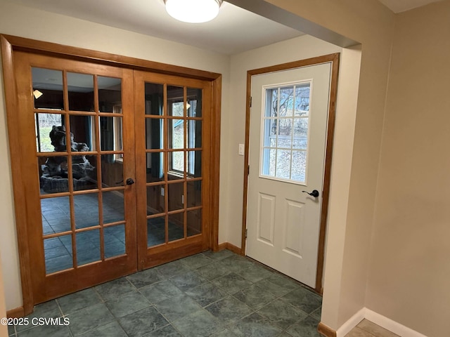 doorway featuring french doors and baseboards