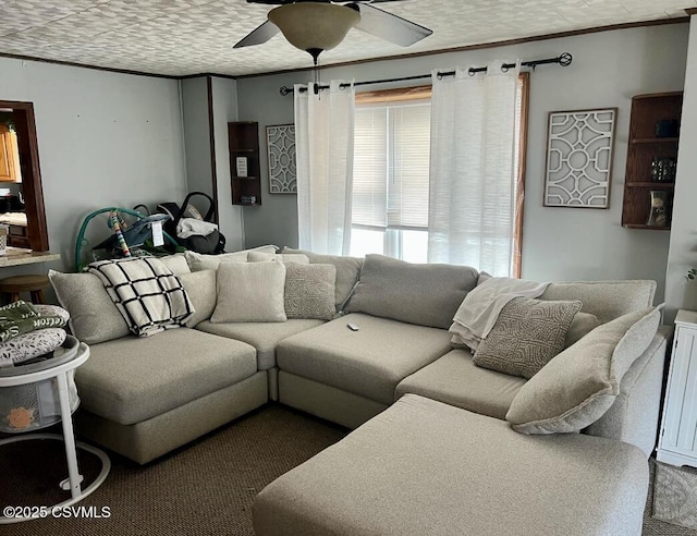 living area featuring ceiling fan, a textured ceiling, and crown molding