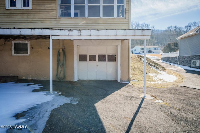 garage with aphalt driveway