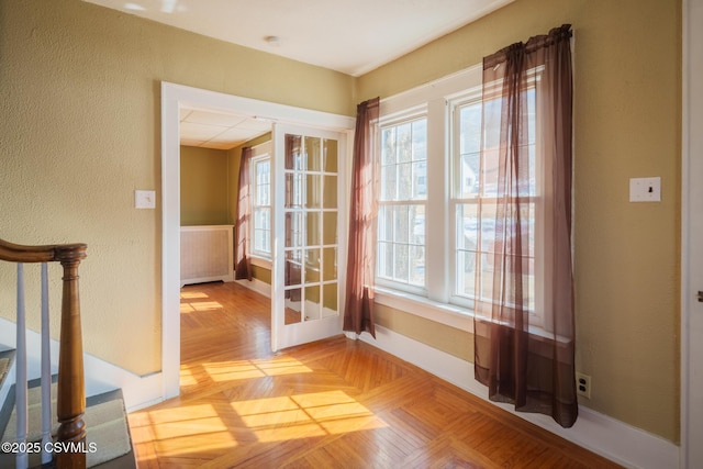 entryway with plenty of natural light, baseboards, and stairs