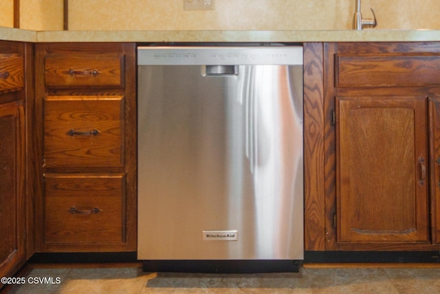 details featuring dishwasher, light countertops, and brown cabinets