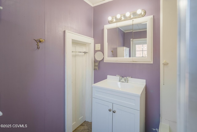 bathroom with ornamental molding and vanity