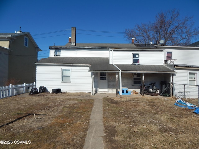 back of house with covered porch and fence